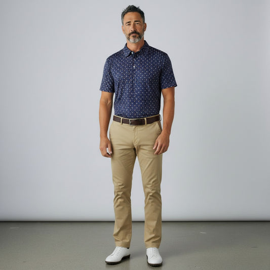 Byron Nelson Firework Polo in navy with red, white, and blue pattern, worn by a man with khaki pants and white shoes.