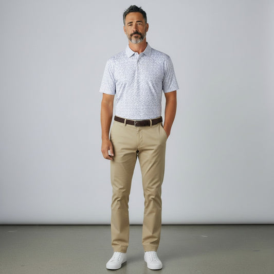 Byron Nelson white short-sleeve polo shirt with blue golfer print, made of polyester and spandex blend.