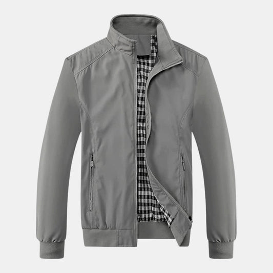 Byron Nelson grey polyester bomber jacket with a black and white checkered lining and zippered pockets.