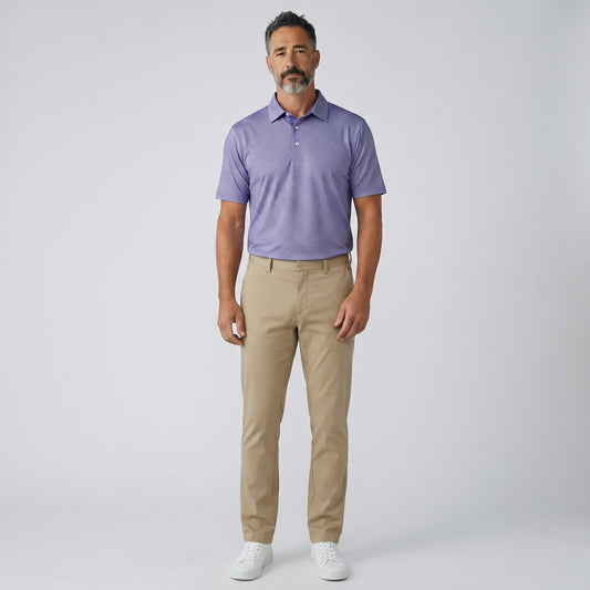 Byron Nelson Maritime Mesh polo shirt in purple with a geometric pattern, paired with khaki pants. Moisture-wicking and stretch fabric.