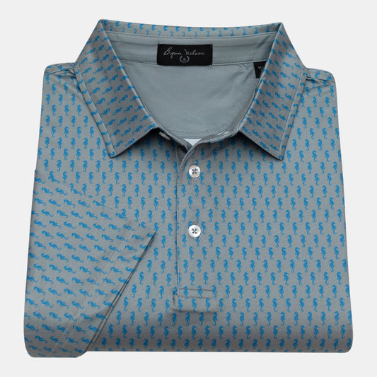 Byron Nelson grey polo shirt with blue seahorse print, short sleeves, and button collar. Made from polyester/spandex performance fabric.
