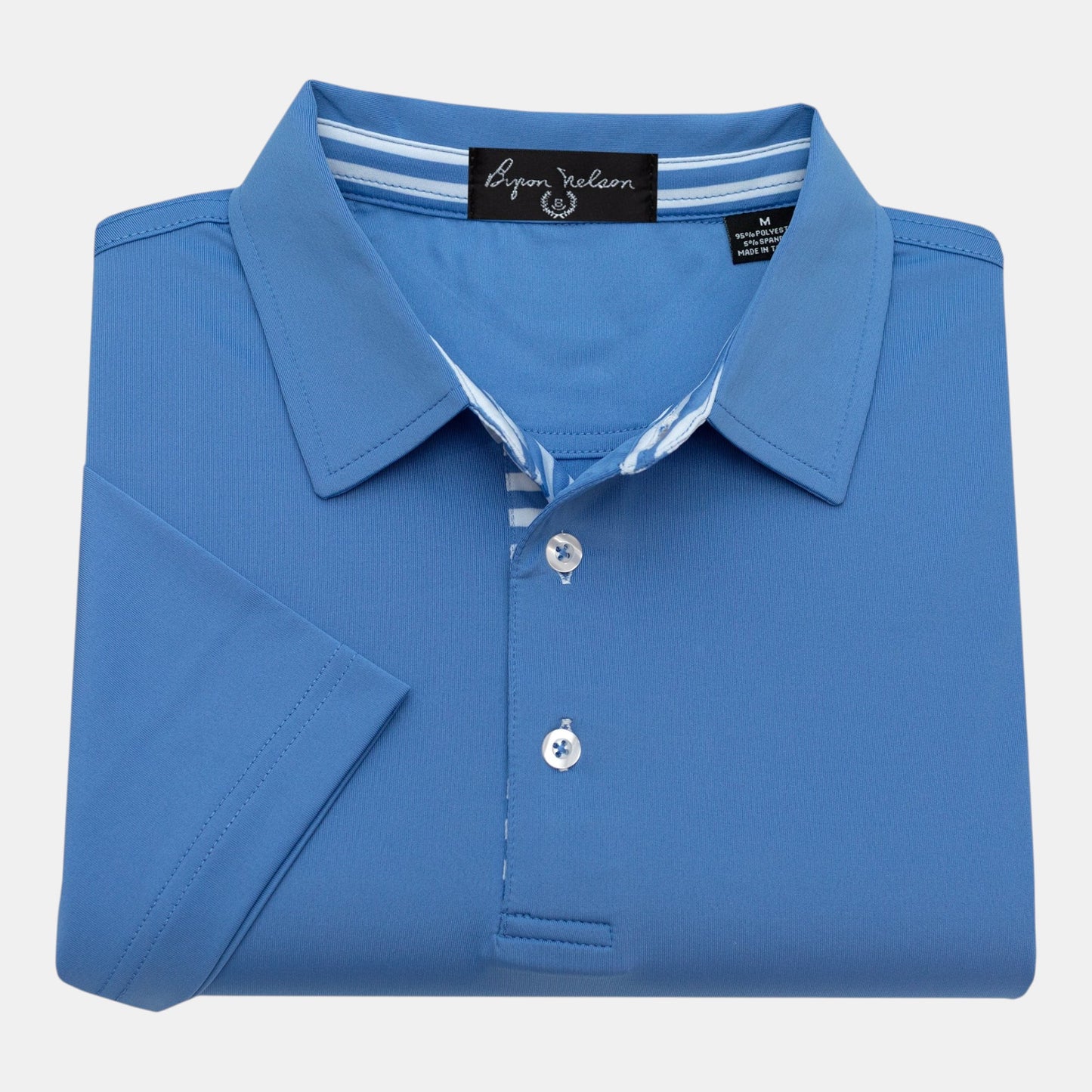 Byron Nelson blue short-sleeve polo shirt with striped placket and neck band. Made from polyester-spandex blend.