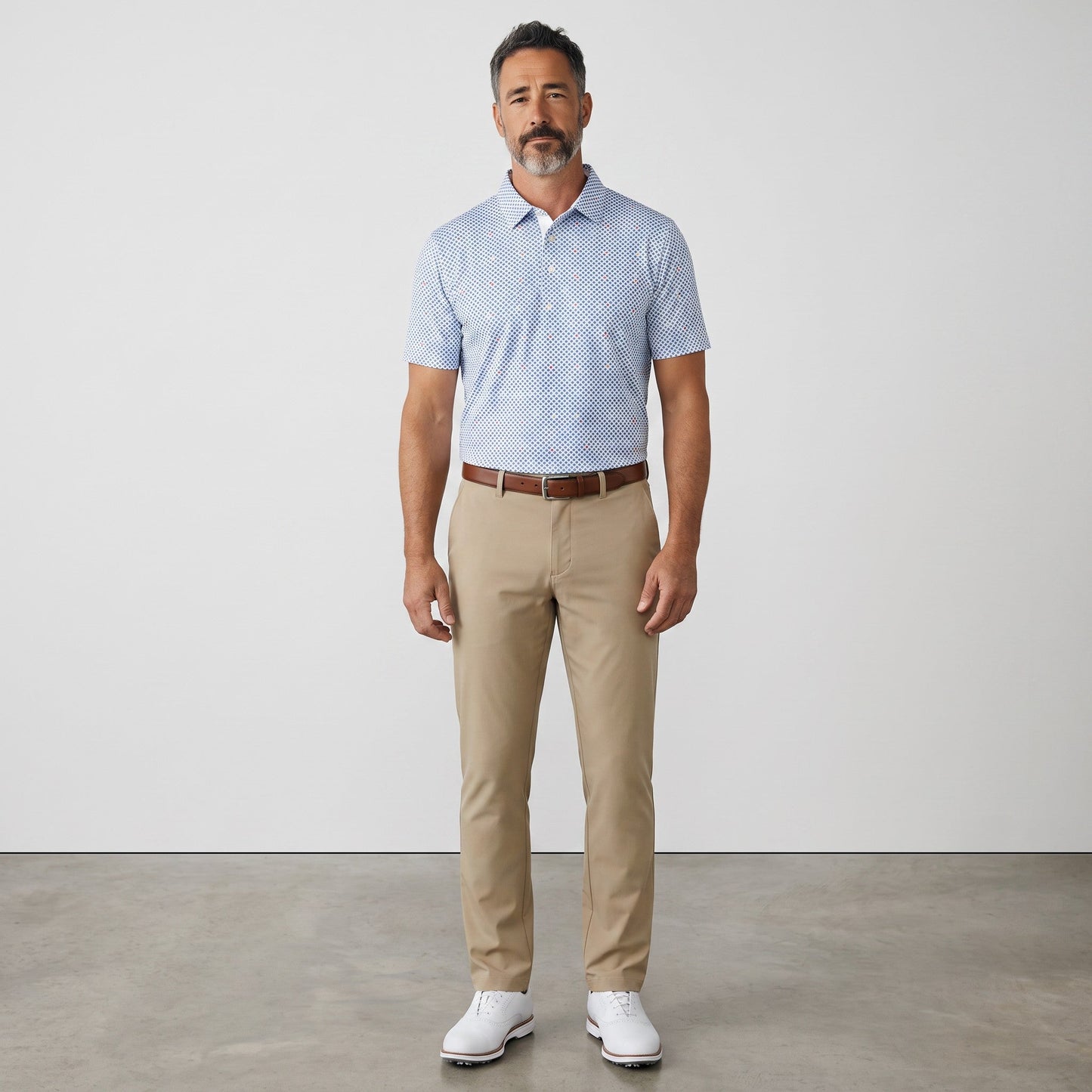 Byron Nelson Bluegrass Bloom polo shirt with blue geometric pattern, worn by a man with khaki trousers.