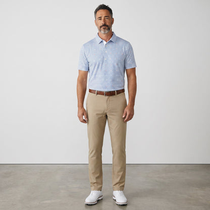 Byron Nelson Bluegrass Bloom polo shirt with blue geometric pattern, worn by a man with khaki trousers.