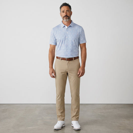 Byron Nelson Bluegrass Bloom polo shirt with blue geometric pattern, worn by a man with khaki trousers.