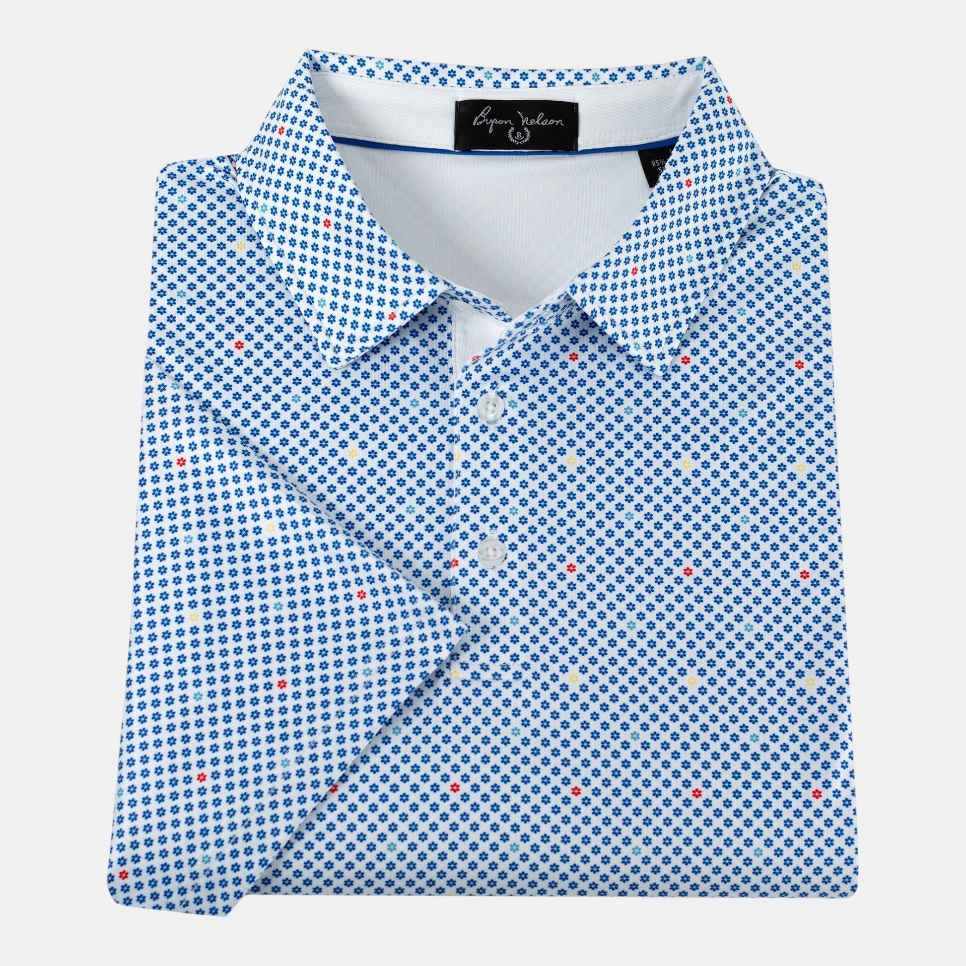 Byron Nelson Bluegrass Bloom polo shirt in white with a blue, red, and yellow floral pattern and moisture-wicking fabric