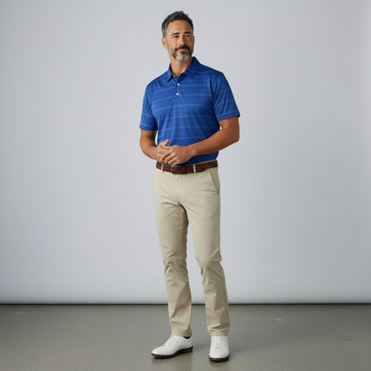 Byron Nelson Caddie Stripe blue moisture-wicking golf polo shirt worn by a man with beige trousers and white shoes