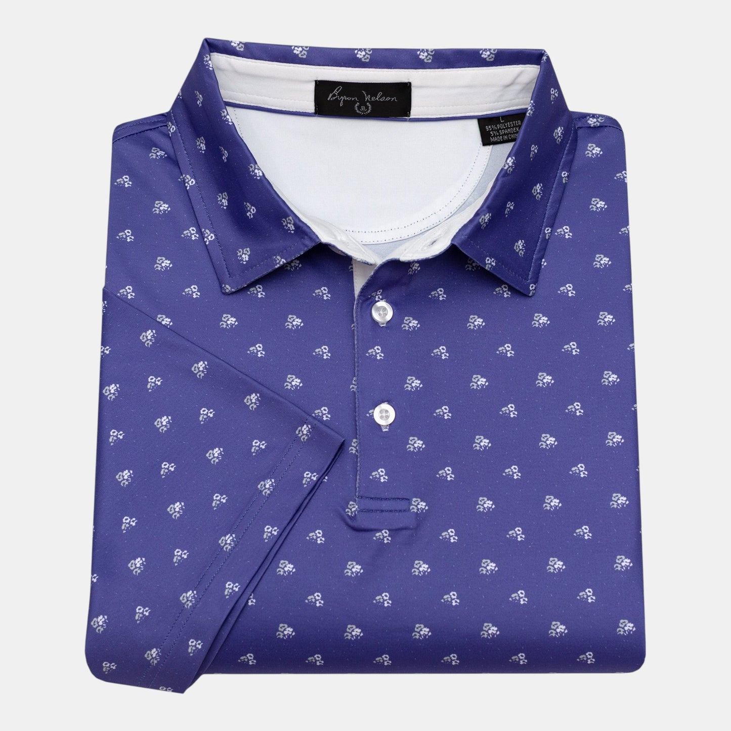 Byron Nelson Carolina Bloom purple golf polo with white floral pattern, 95% polyester/5% spandex blend.