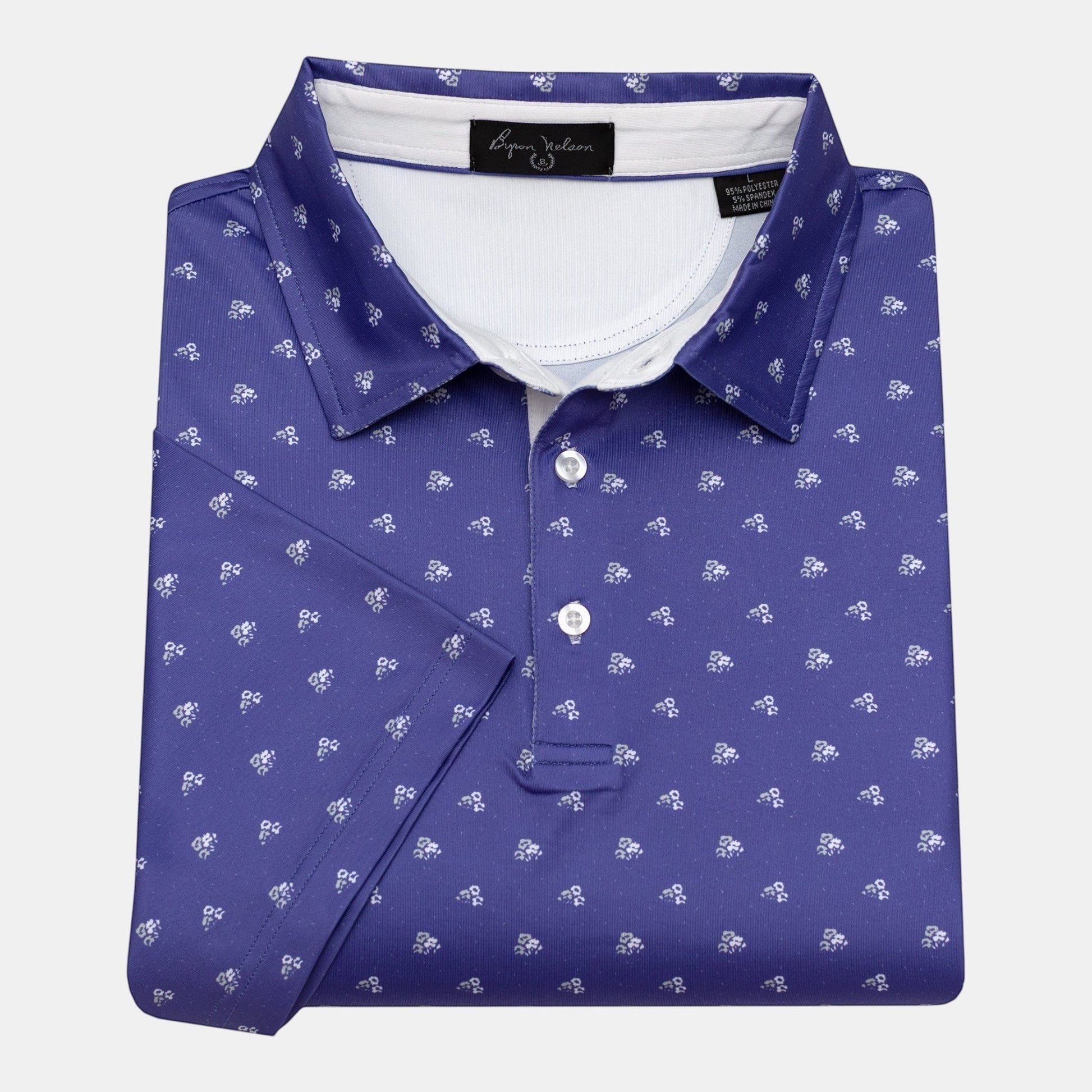 Byron Nelson Carolina Bloom purple golf polo with white floral pattern, 95% polyester/5% spandex blend.