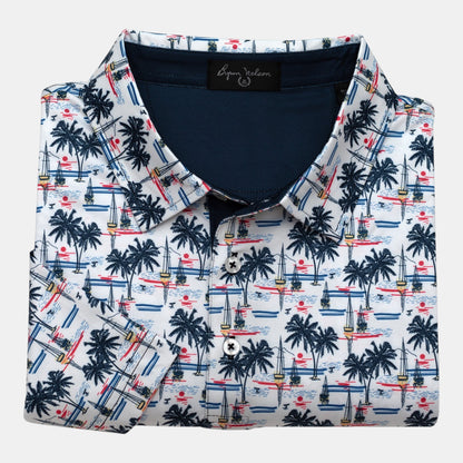 Byron Nelson white polo with all-over palm trees, sailboats, and sunset print. Moisture-wicking fabric.