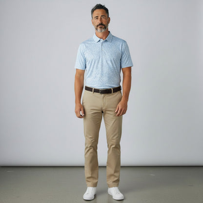 Byron Nelson light blue dog print golf polo shirt worn by a man with khaki trousers and white sneakers.