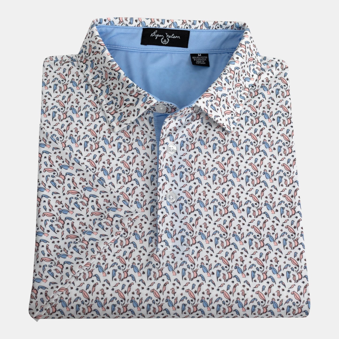 Byron Nelson Fairway Flock polo shirt with a white base and a repeating parrot print in pink and blue. Made of polyester and spandex.