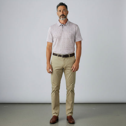 Byron Nelson The Firecracker Polo shirt with a red, white, and blue firework pattern on a navy background. Made of polyester and spandex.