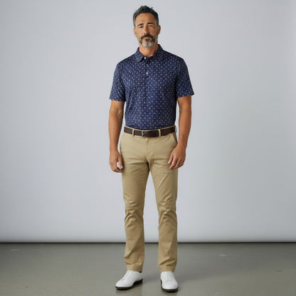 Byron Nelson Firework Polo in navy with red, white, and blue pattern, worn by a man with khaki pants and white shoes.