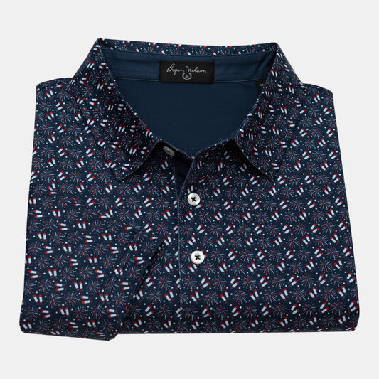 Byron Nelson navy blue polo shirt with all-over red, white, and blue firework pattern. Made from polyester and spandex blend.