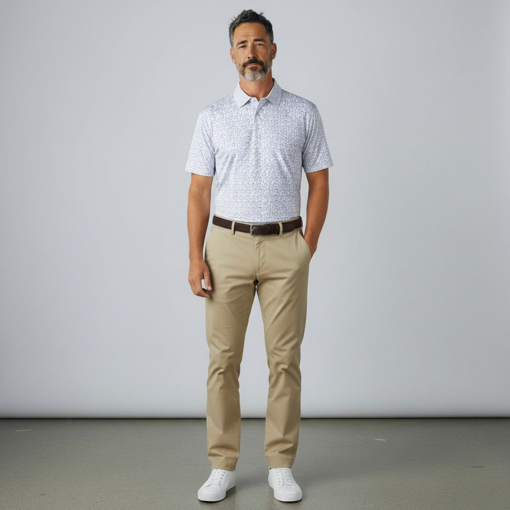 Byron Nelson white short-sleeve polo shirt with blue golfer print, made of polyester and spandex blend.