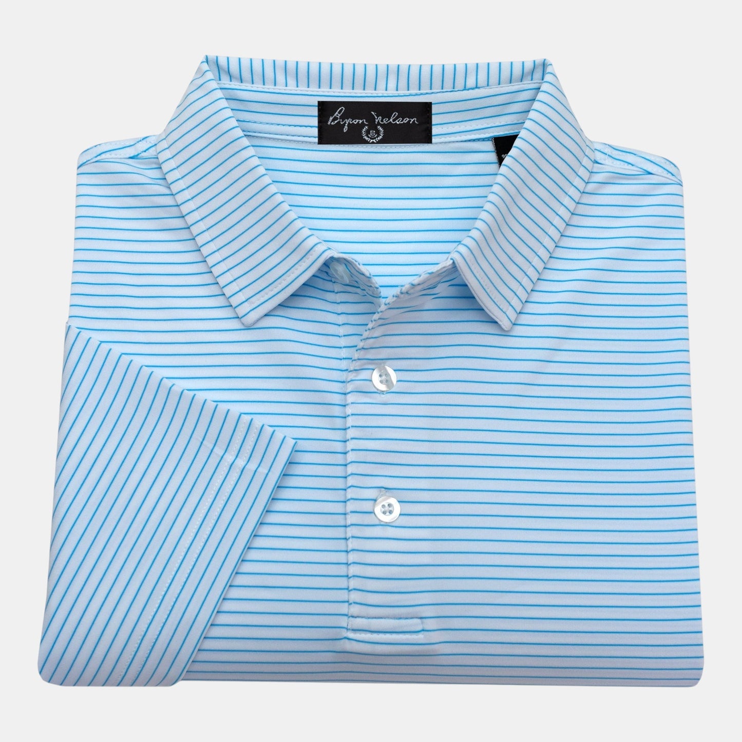 Byron Nelson Key West Polo in Baltic Blue with white stripes. 95% polyester, 5% spandex blend with moisture-wicking.