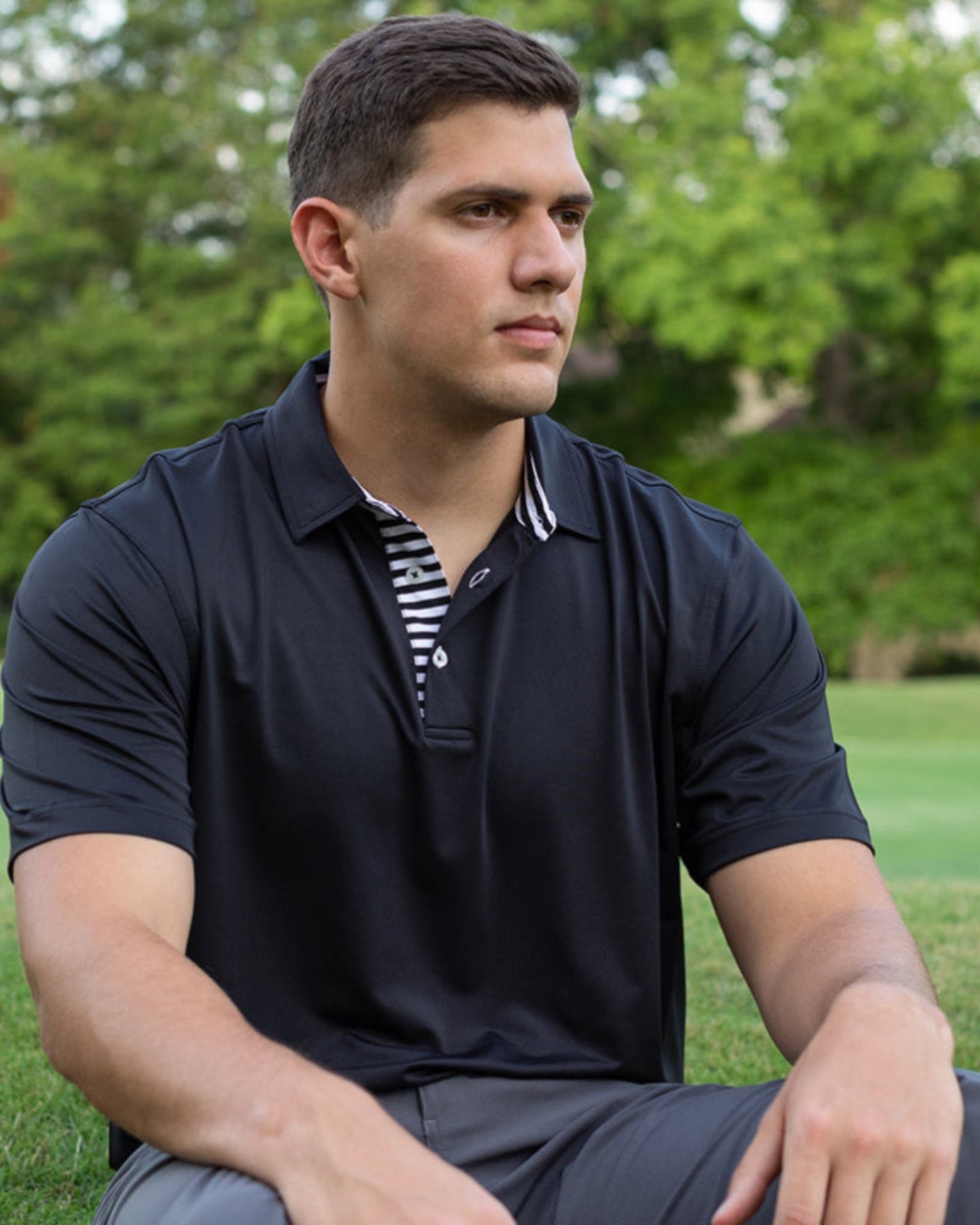 Byron Nelson Miami Polo: Black performance fabric short-sleeve polo with striped placket and neck. Athletic fit.