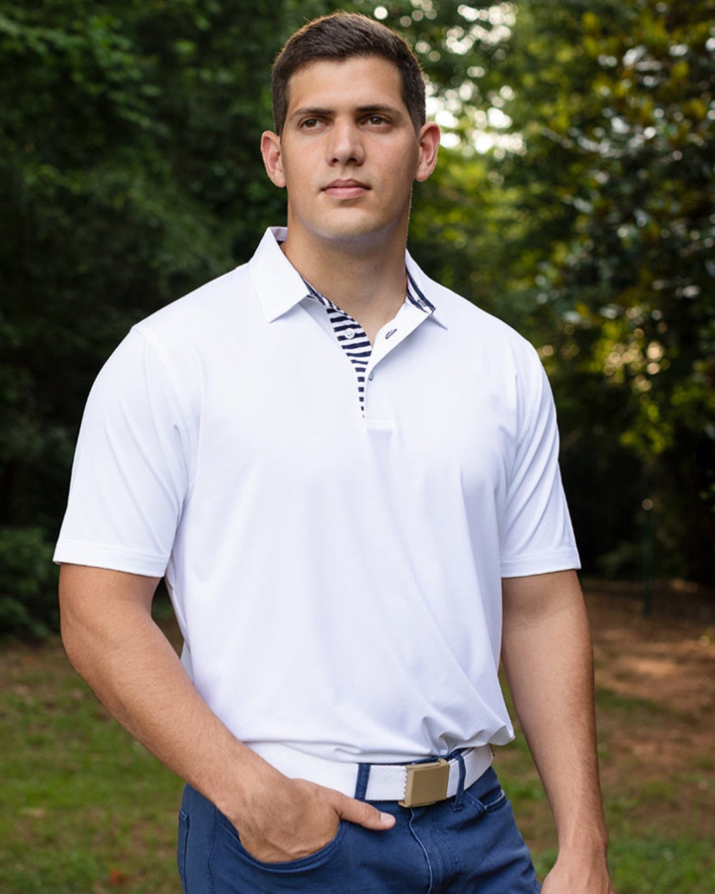 Byron Nelson Miami Polo: White performance fabric short-sleeve polo with navy striped placket and collar detail.