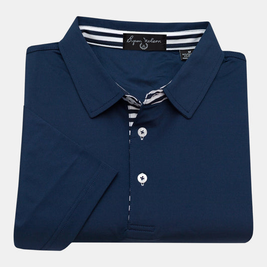 Byron Nelson navy blue performance polo shirt with white striped placket and collar. 95% Polyester / 5% Spandex.