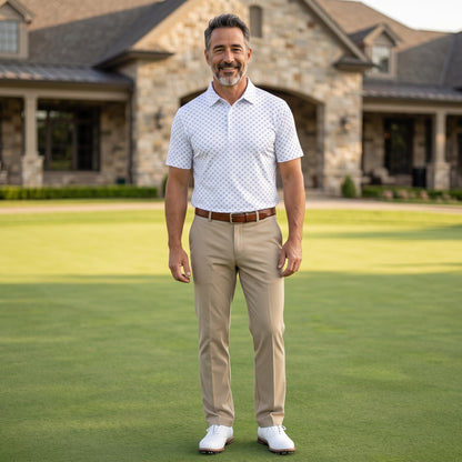 Byron Nelson Newport Polo in white with a blue geometric print, worn by a smiling man on a golf course.