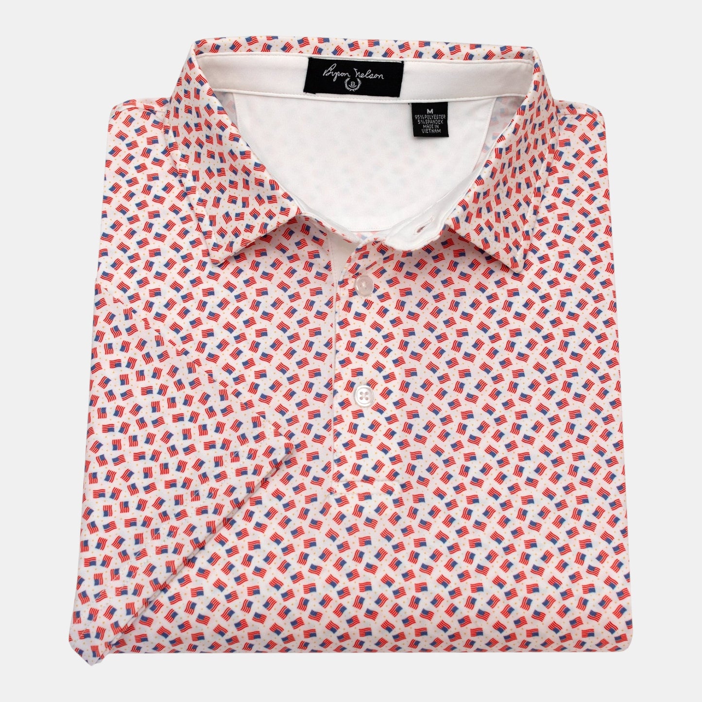 Byron Nelson white polo shirt with all-over print of small American flags and gold stars. Made of polyester and spandex.