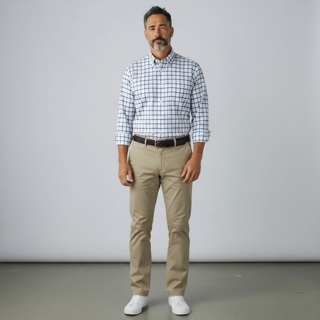 Byron Nelson performance button down shirt with a blue grid pattern, worn by a man with khaki trousers.