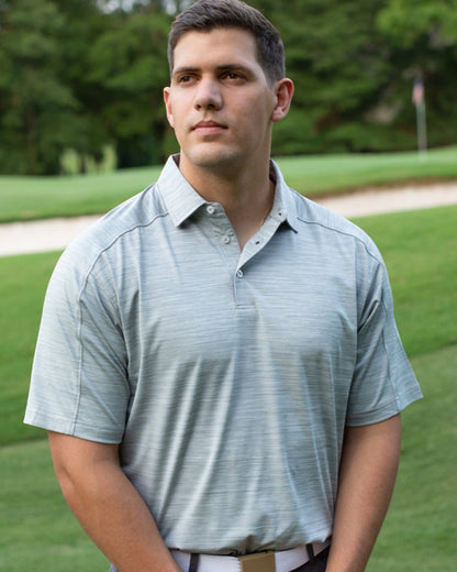 Byron Nelson light blue heathered performance polo shirt with raglan sleeves, made of polyester and spandex blend.