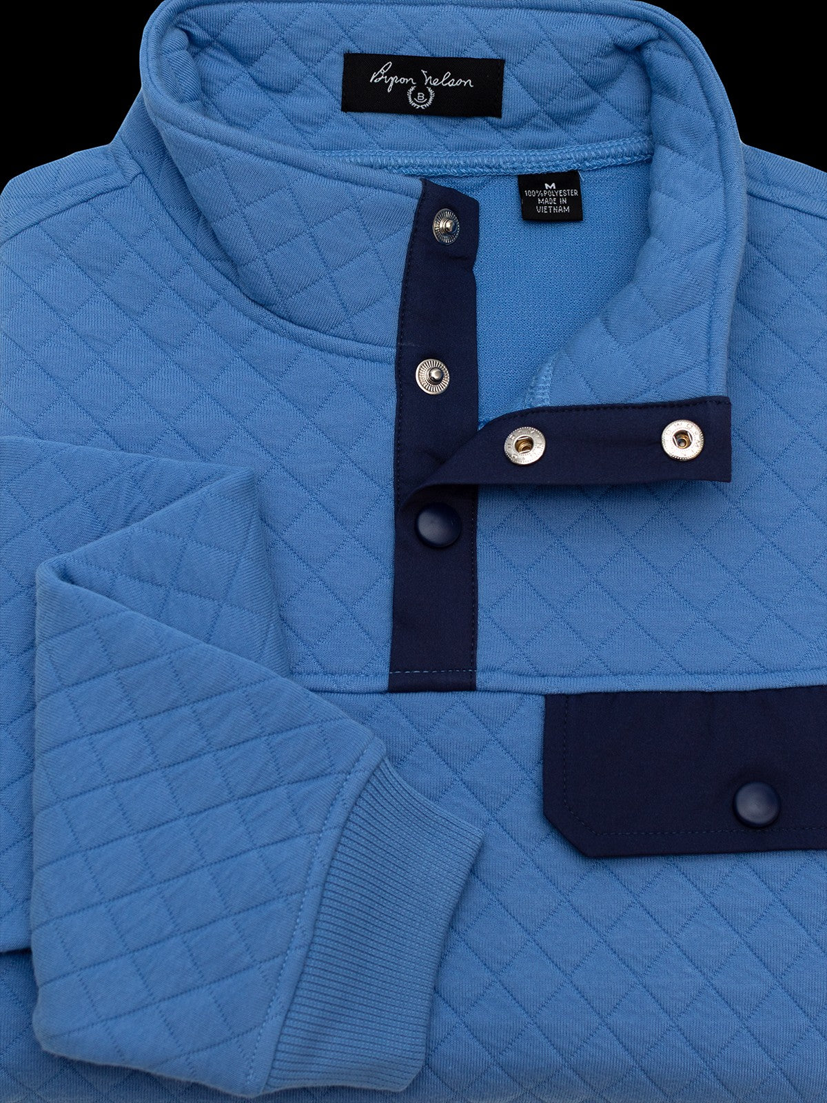 Byron Nelson sky blue quilted pullover with navy accents on the snap placket and chest pocket. Cotton-polyester blend.