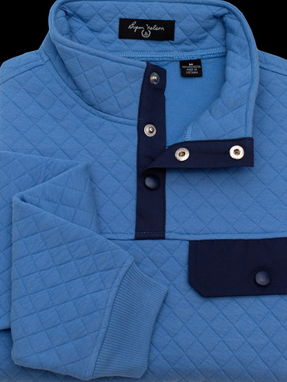 Byron Nelson sky blue quilted pullover with navy accents on the snap placket and chest pocket. Cotton-polyester blend.