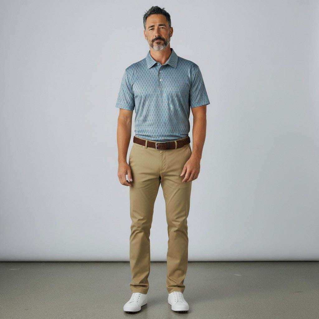Byron Nelson Reef Rider blue performance polo with seahorse print worn by a man with khaki trousers and white shoes