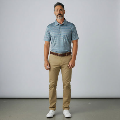 Byron Nelson Reef Rider blue performance polo with seahorse print worn by a man with khaki trousers and white shoes