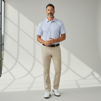Byron Nelson Seaside Stripe polo shirt in light blue and white worn by a man with beige trousers and golf shoes.