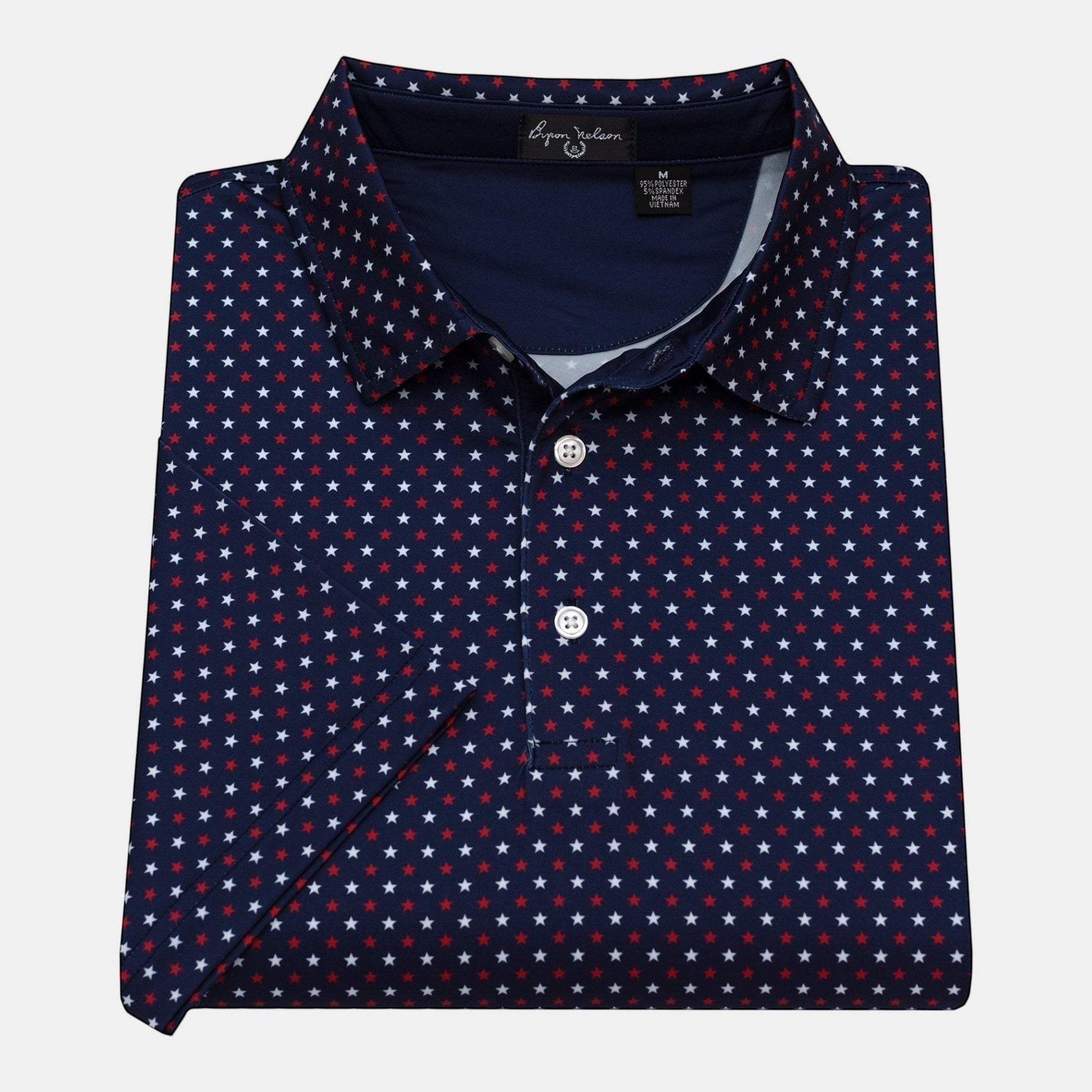 Byron Nelson navy blue polo shirt with a repeating red and white star pattern. Made from polyester and spandex.