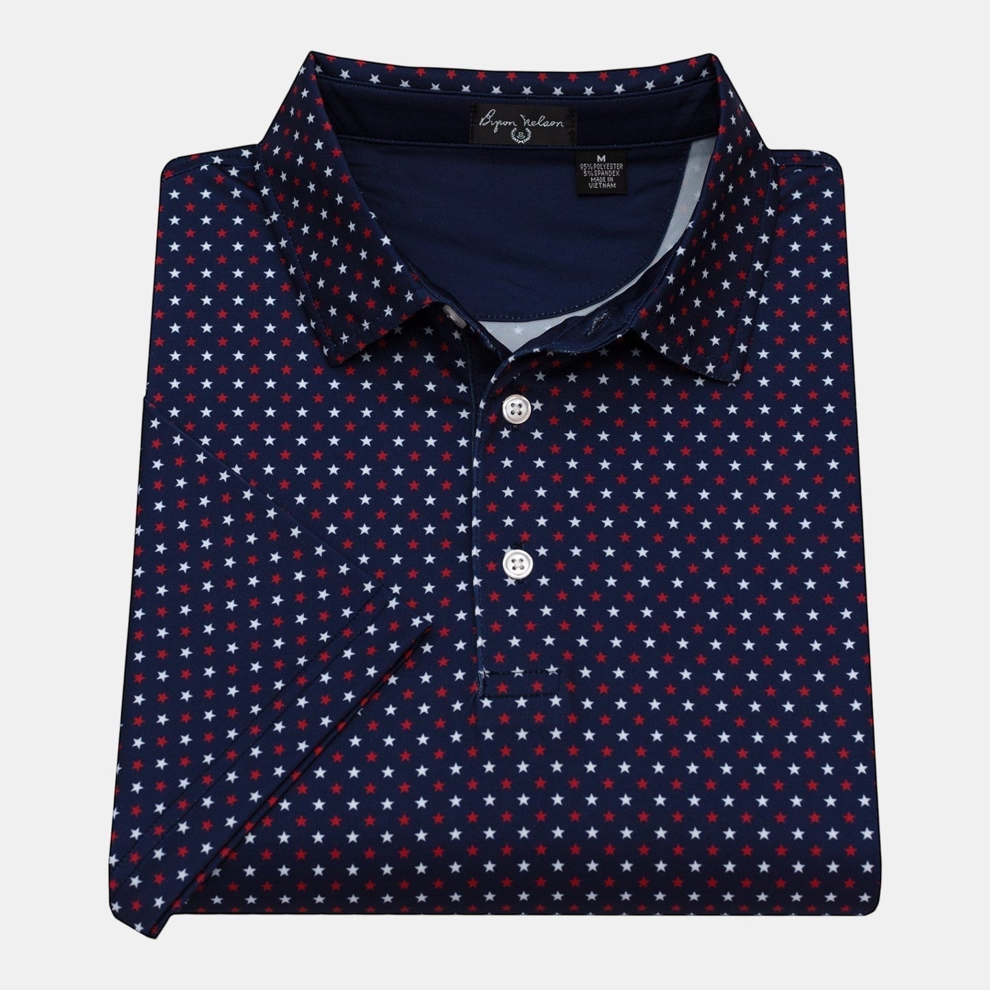 Byron Nelson navy blue polo shirt with a red and white star print. Made of polyester and spandex with moisture-wicking fabric.