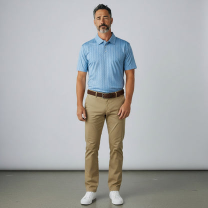 Byron Nelson Windward polo shirt in light blue with a subtle pattern, paired with khaki trousers and white sneakers.